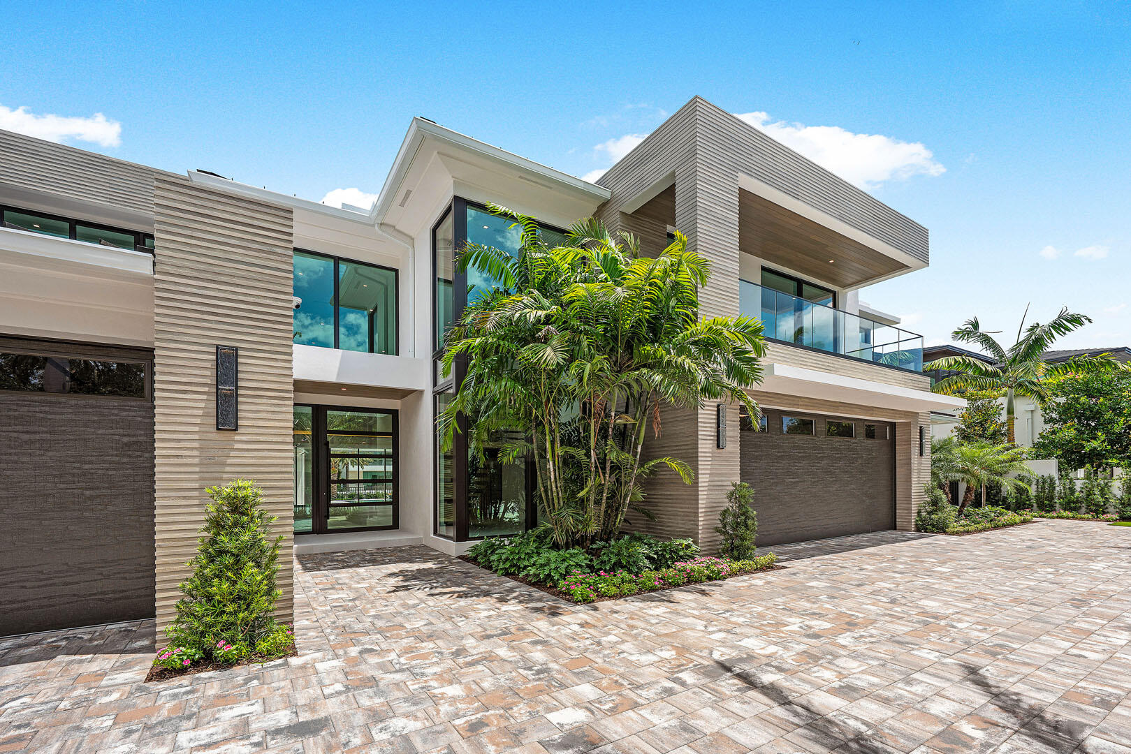 191 Coconut Palm Road Boca Raton, FL 33432 - Photo 6 of 81 a front view of a house with a yard and garage
