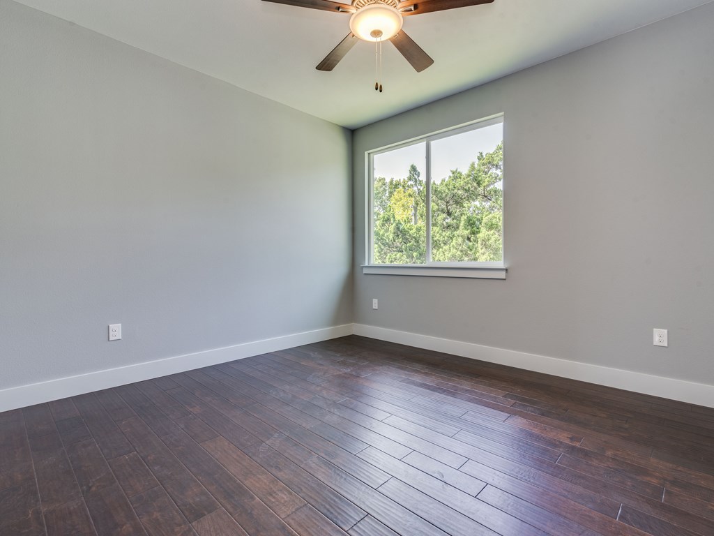 406 Post Rd Drive, Unit 1 Austin, TX 78704 - Photo 15 of 30 secondary bedroom with large window, wood floors and ceiling fan