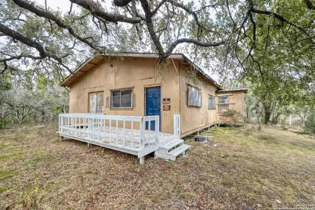 a house that has a tree in front of the house