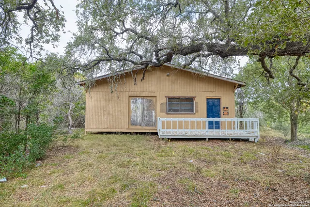 a front view of a house with a garden and yard