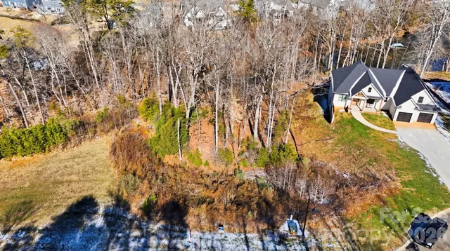 a view of a yard with wooden fence