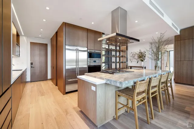 a view of a dining room with furniture large windows and wooden floor