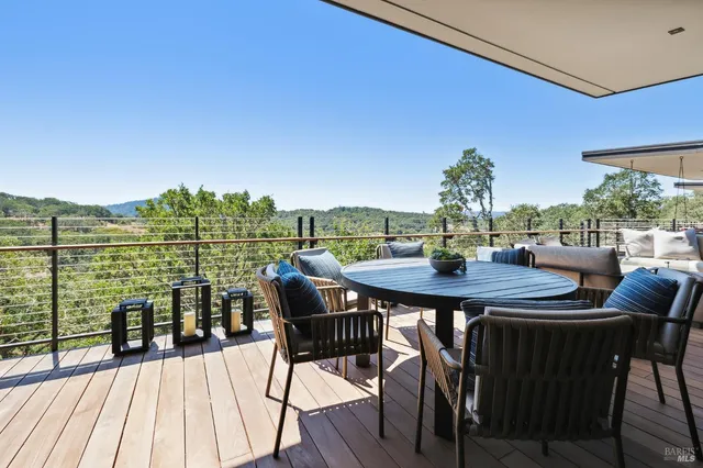 a view of a patio with a table chairs and a backyard