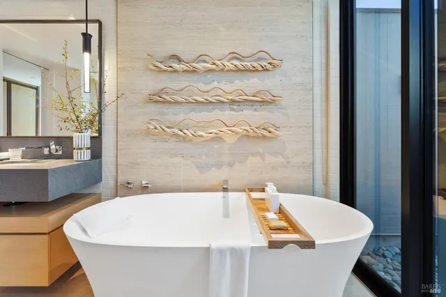 a bathroom with a sink toilet double vanity and shower