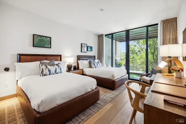 a bathroom with a double vanity sink a mirror and a shower