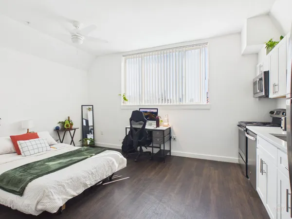 a bedroom with a bed and a window