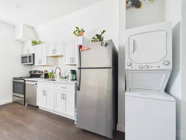 a white refrigerator freezer sitting in a kitchen