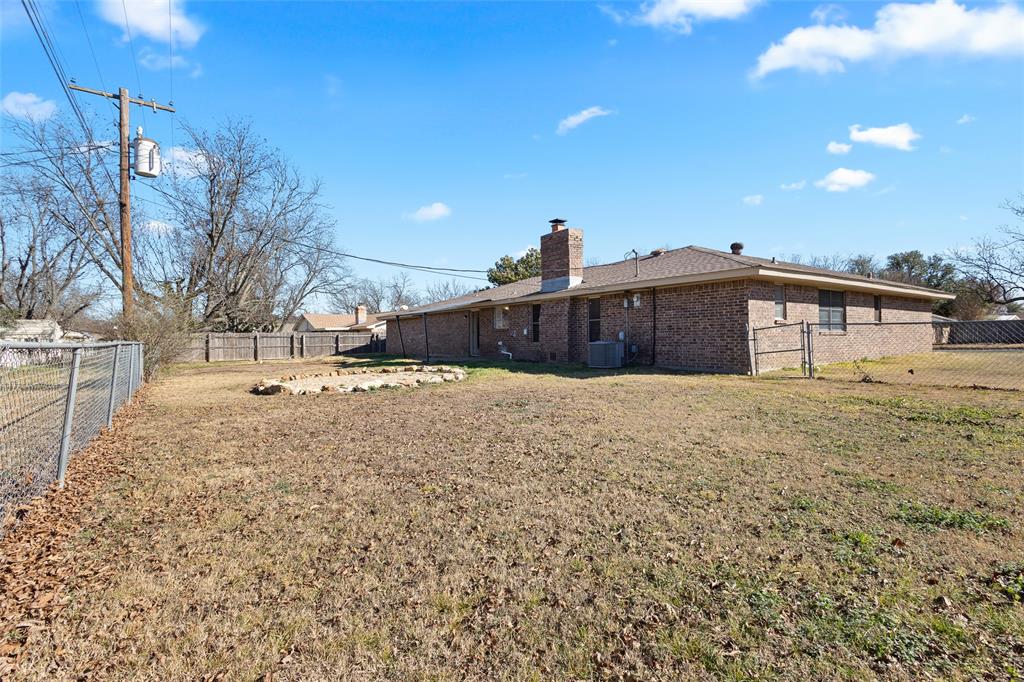 1206 Anetta Street Bowie, TX 76230 - Photo 19 of 21 a view of a house with a yard