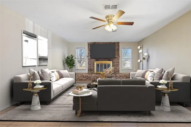 a living room with furniture a fireplace and a ceiling fan
