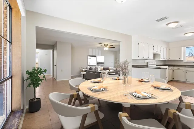 a kitchen with a white table and chairs