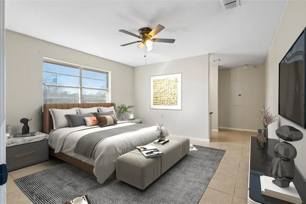 a bedroom with a bed couch and window