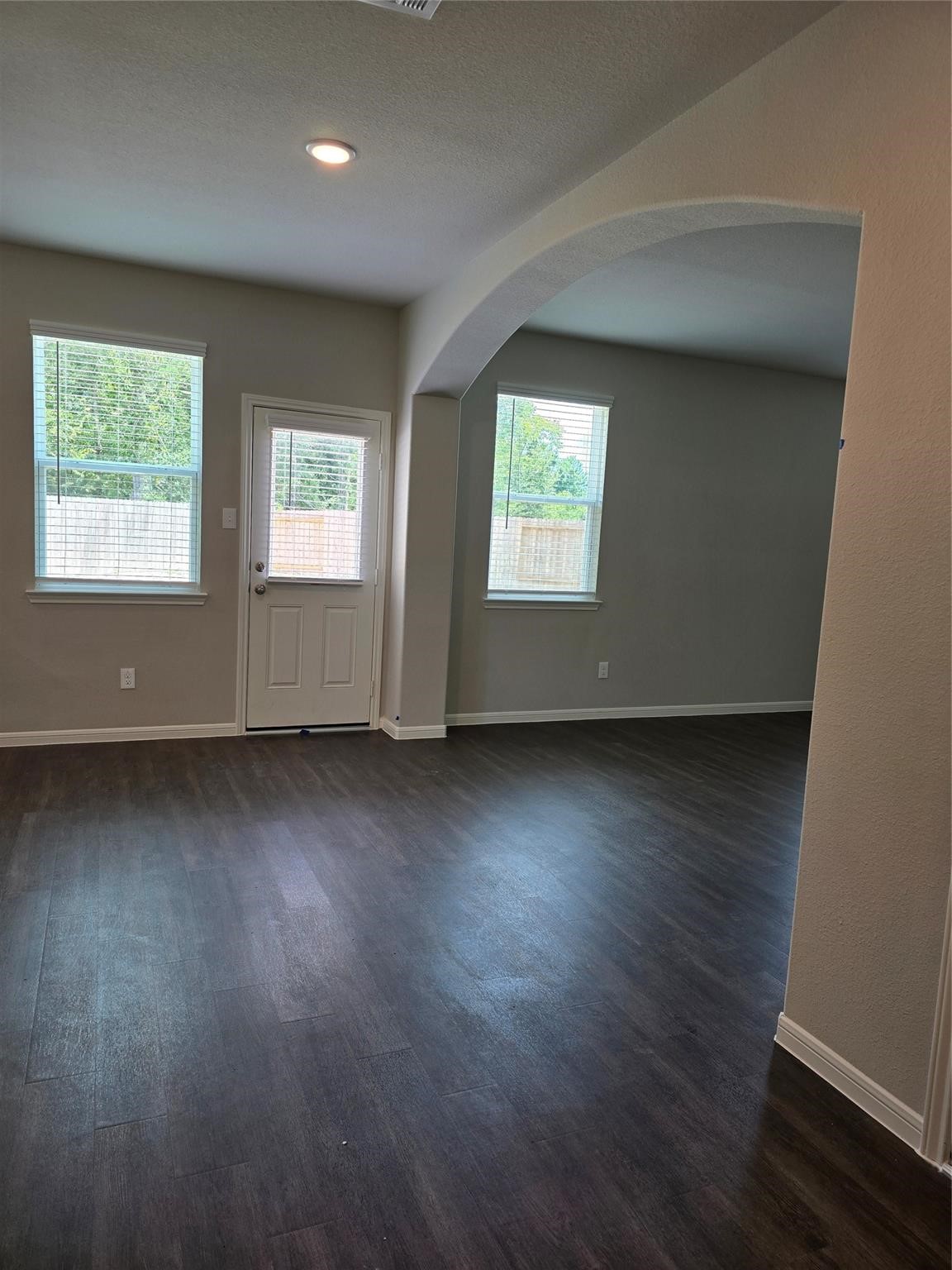 15905 Cy Young Court Splendora, TX 77372 - Photo 9 of 16 an empty room with wooden floor and windows