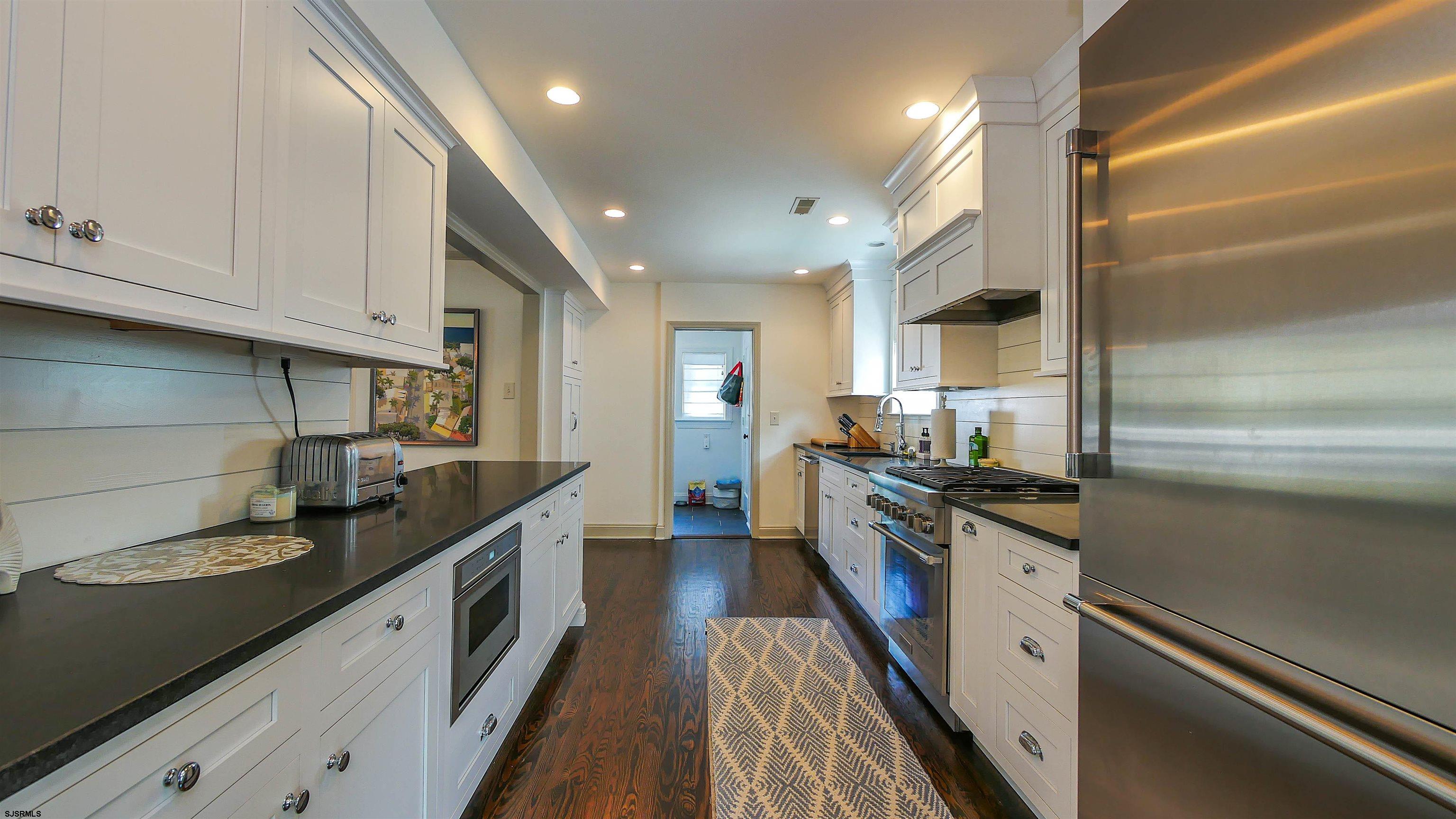 118 Pinnacle Road Ocean City, NJ 08226 - Photo 13 of 49 a kitchen with granite countertop stainless steel appliances and wooden cabinets