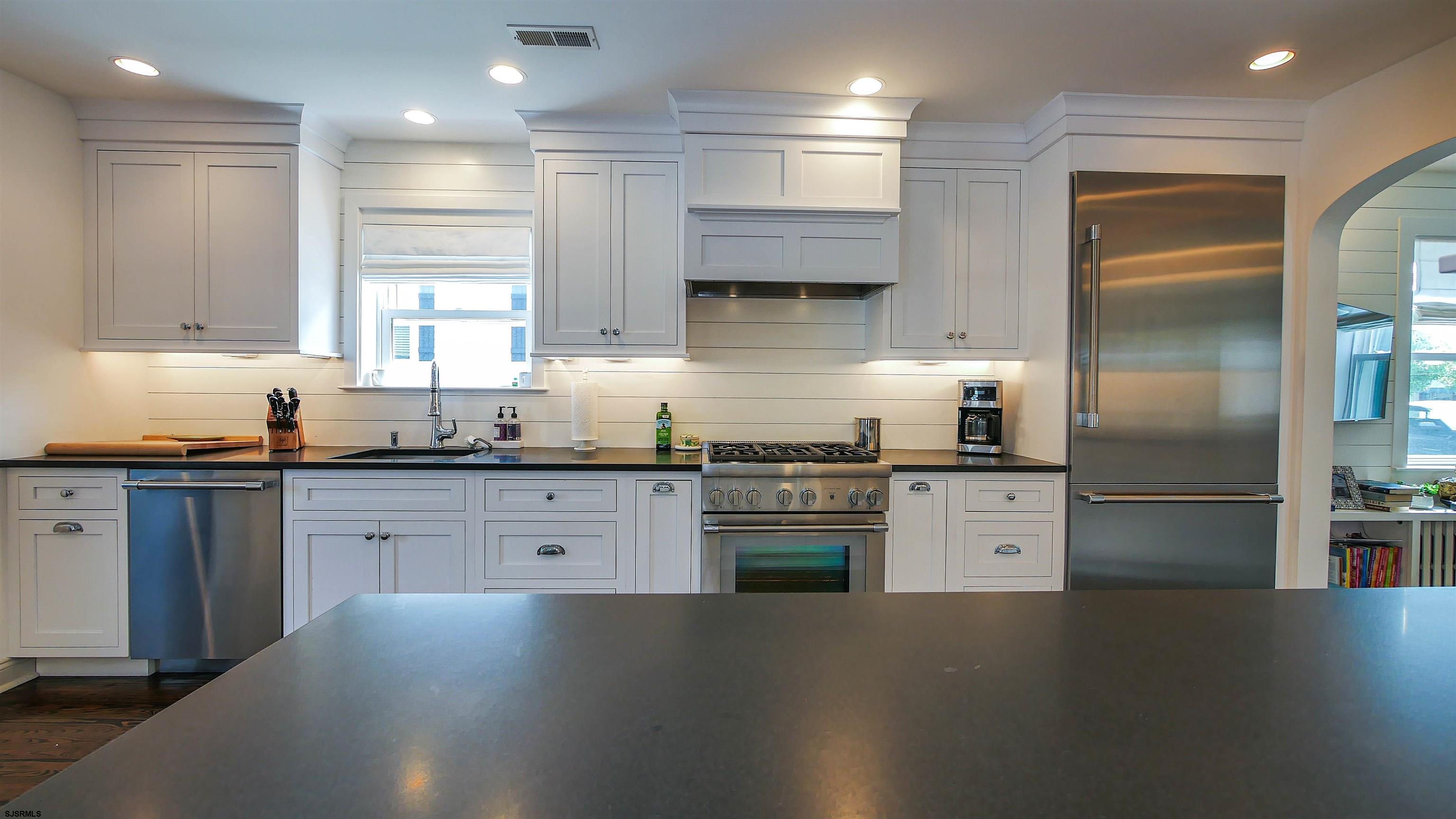 118 Pinnacle Road Ocean City, NJ 08226 - Photo 15 of 49 a kitchen with stainless steel appliances a refrigerator sink stove microwave and cabinets