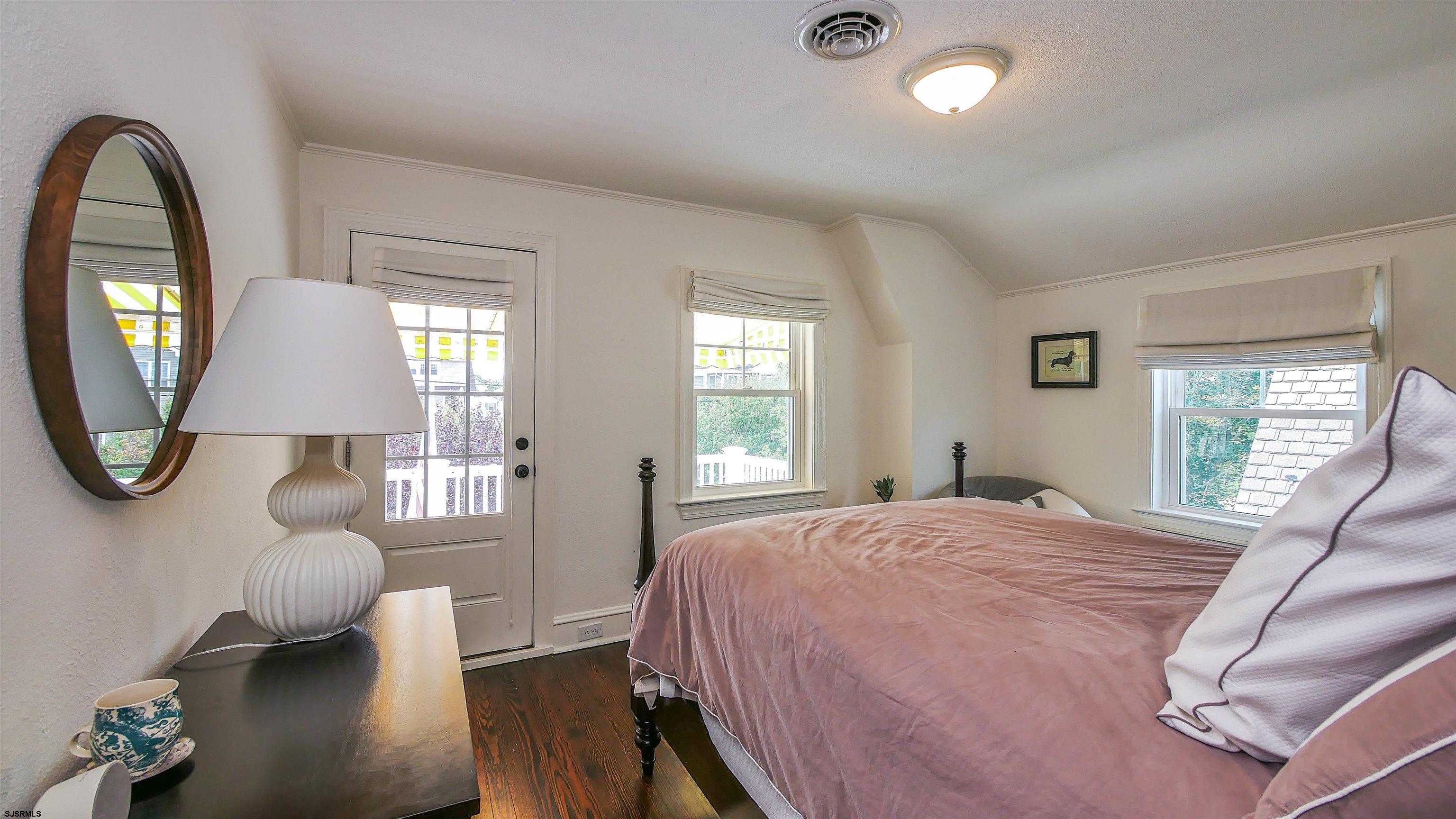 118 Pinnacle Road Ocean City, NJ 08226 - Photo 24 of 49 a spacious bedroom with a bed a mirror and a large window
