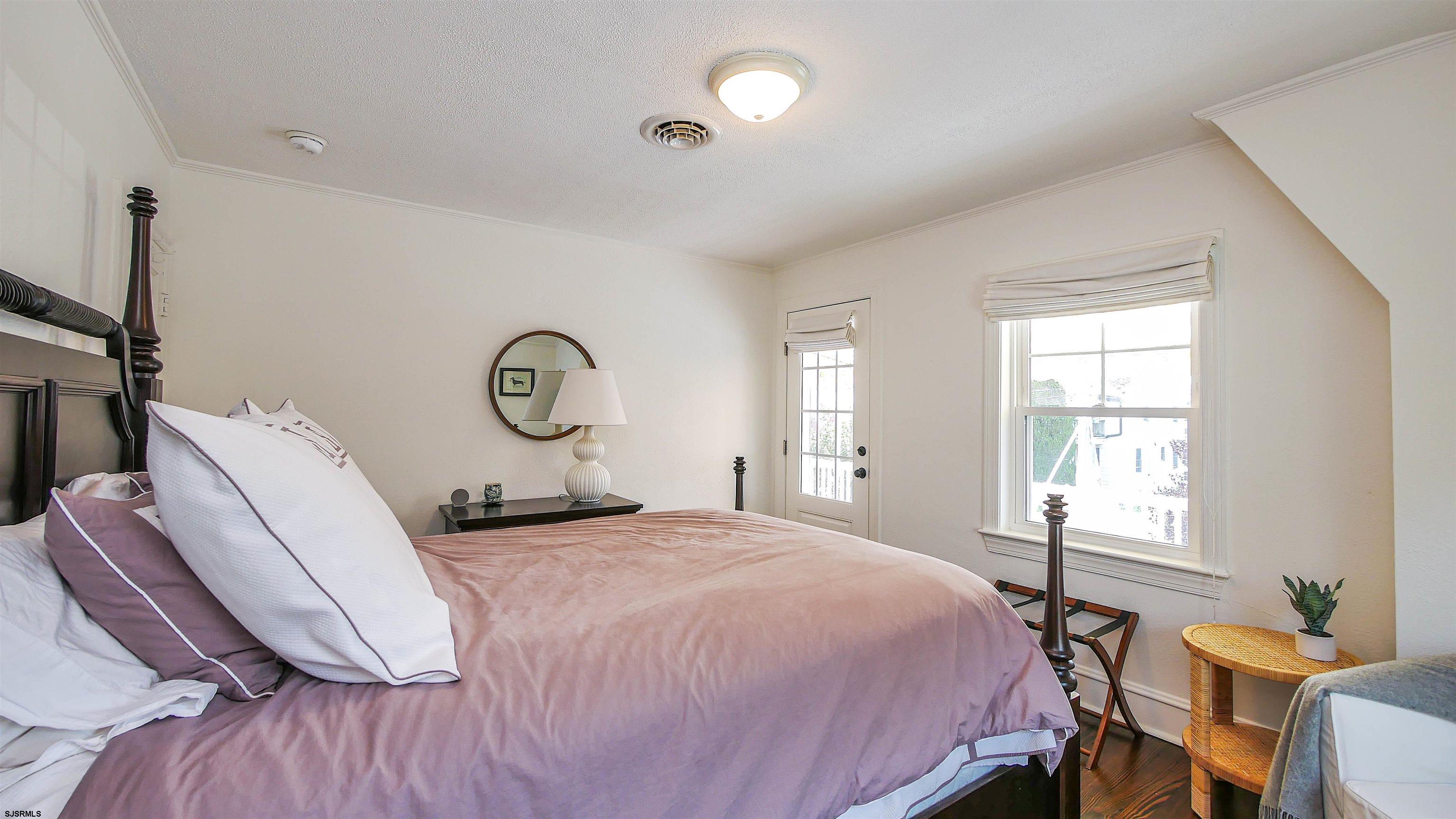 118 Pinnacle Road Ocean City, NJ 08226 - Photo 26 of 49 a bedroom with a bed and window with chair