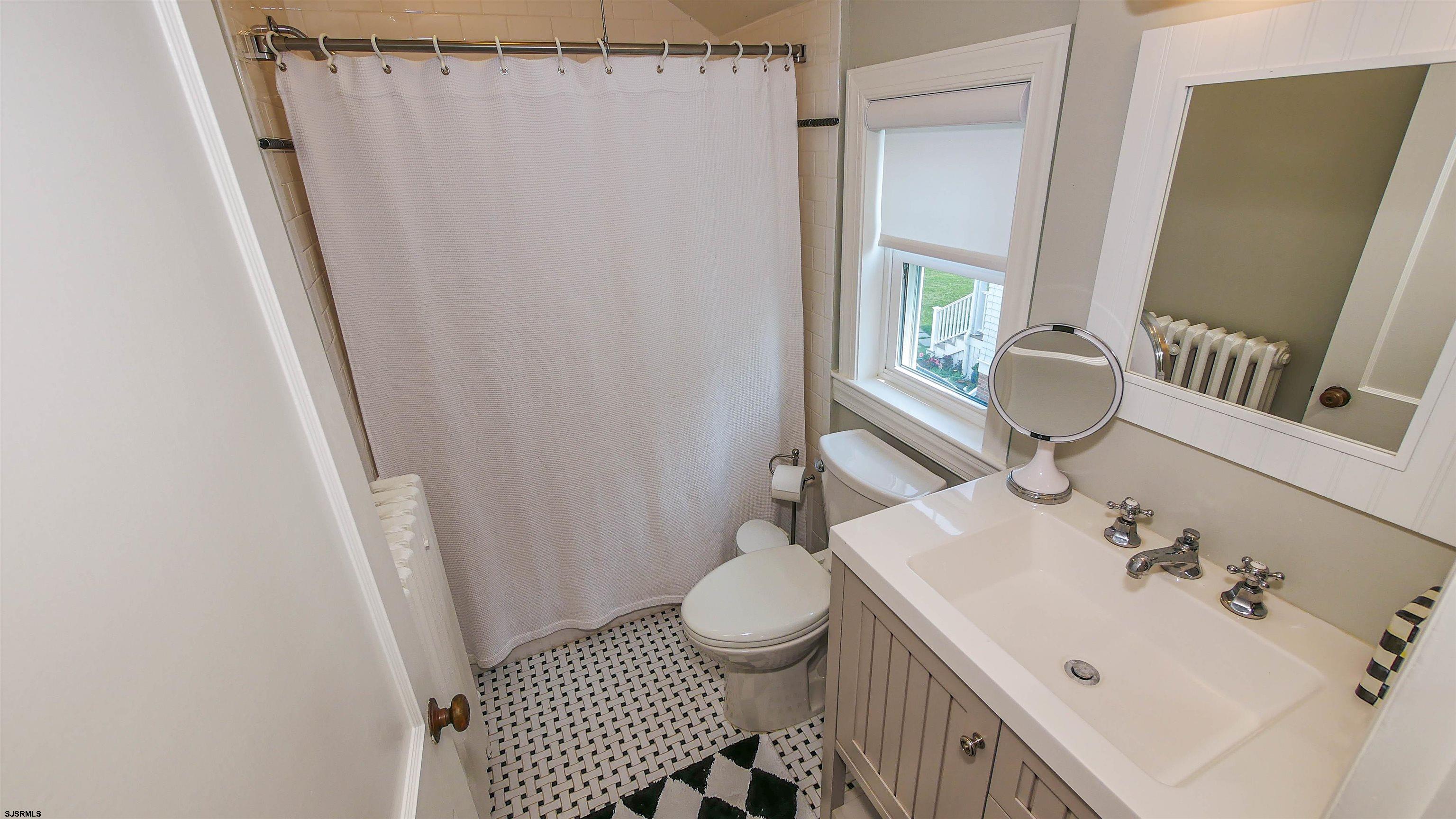118 Pinnacle Road Ocean City, NJ 08226 - Photo 32 of 49 a bathroom with a sink a toilet and shower curtain