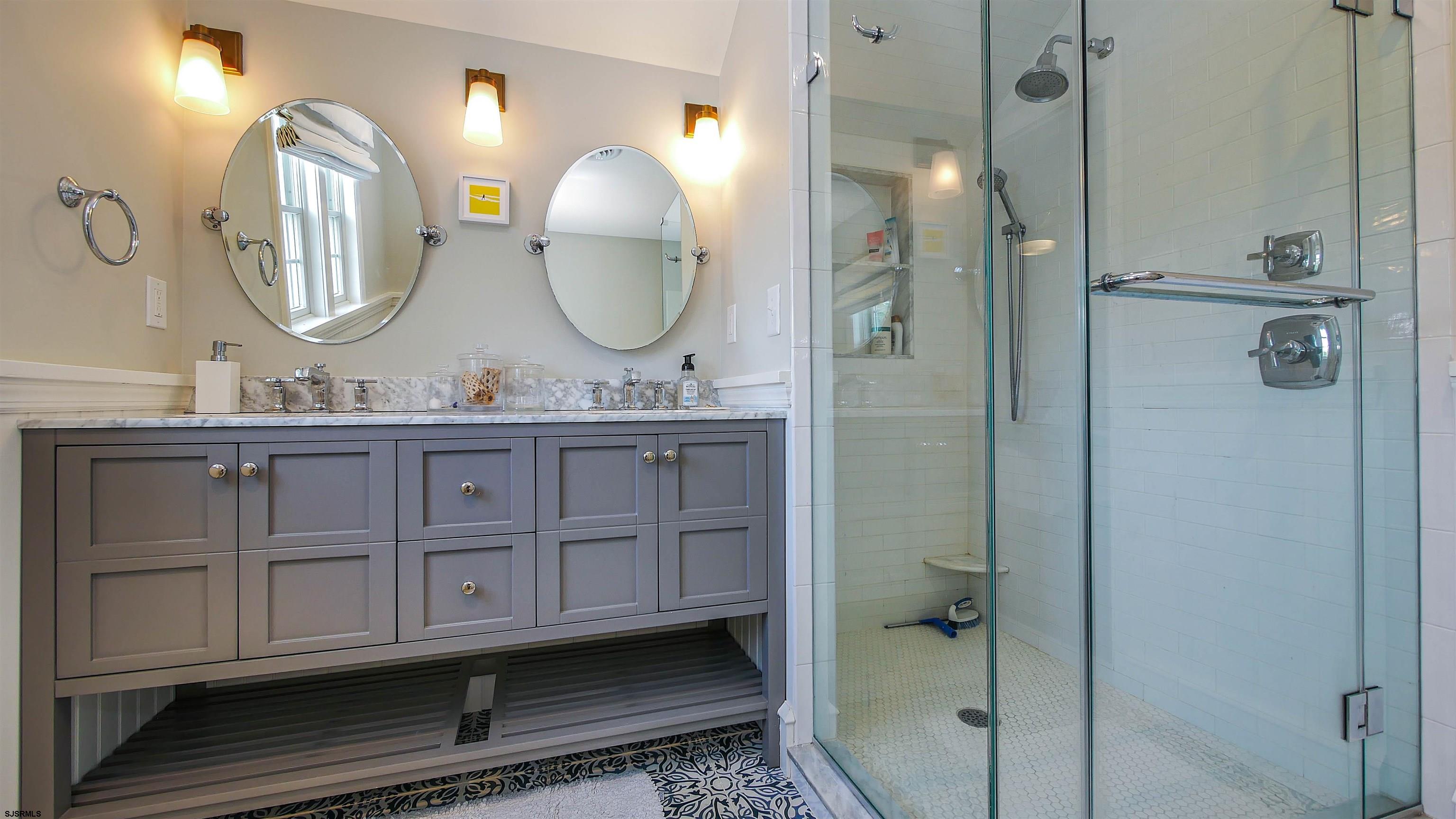 118 Pinnacle Road Ocean City, NJ 08226 - Photo 39 of 49 a bathroom with a double vanity sink a mirror a shower and a mirror