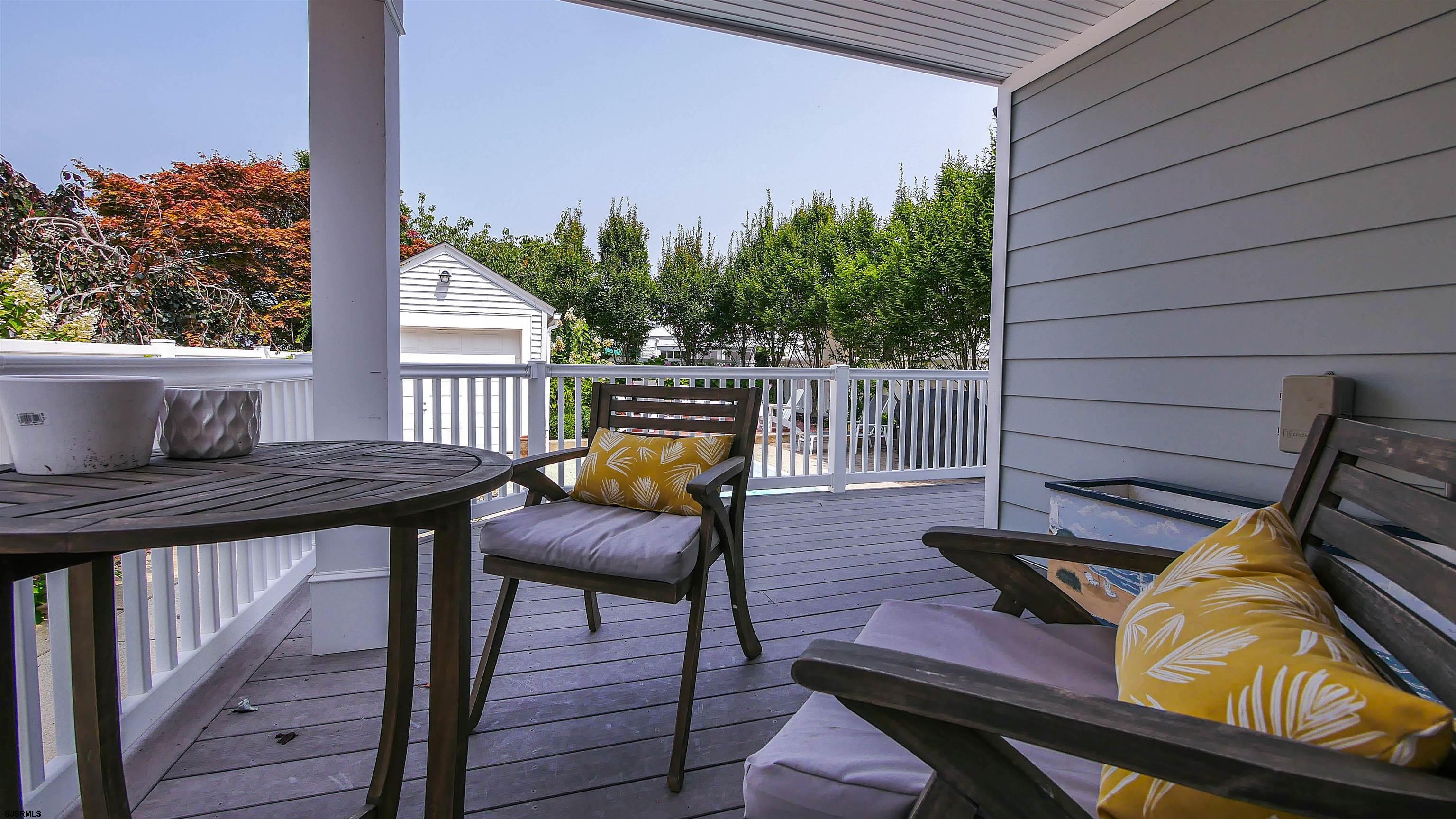 118 Pinnacle Road Ocean City, NJ 08226 - Photo 40 of 49 a view of balcony with wooden floor and outdoor seating