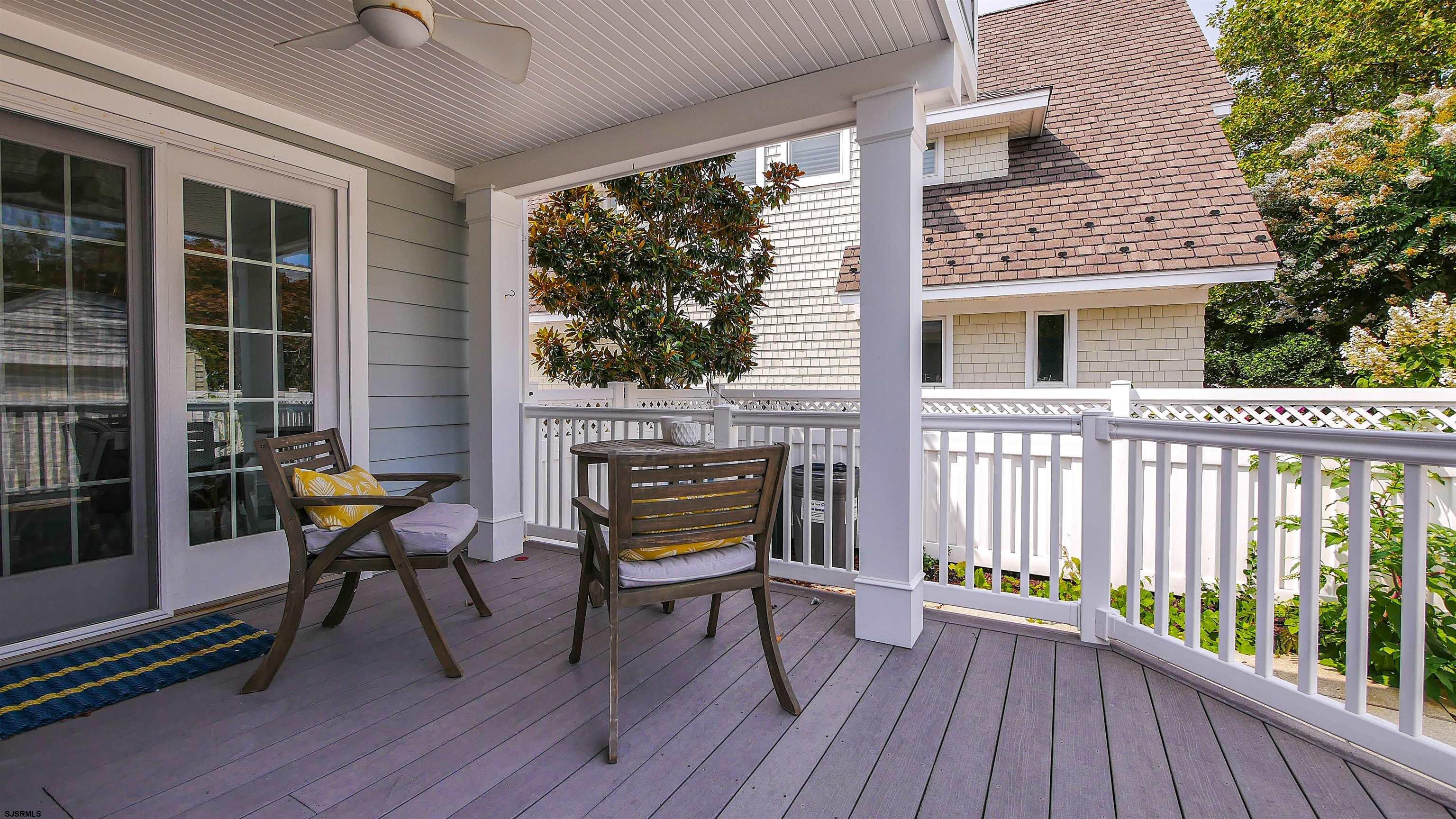 118 Pinnacle Road Ocean City, NJ 08226 - Photo 41 of 49 a view of a deck with table and chairs with wooden floor and floor to ceiling window
