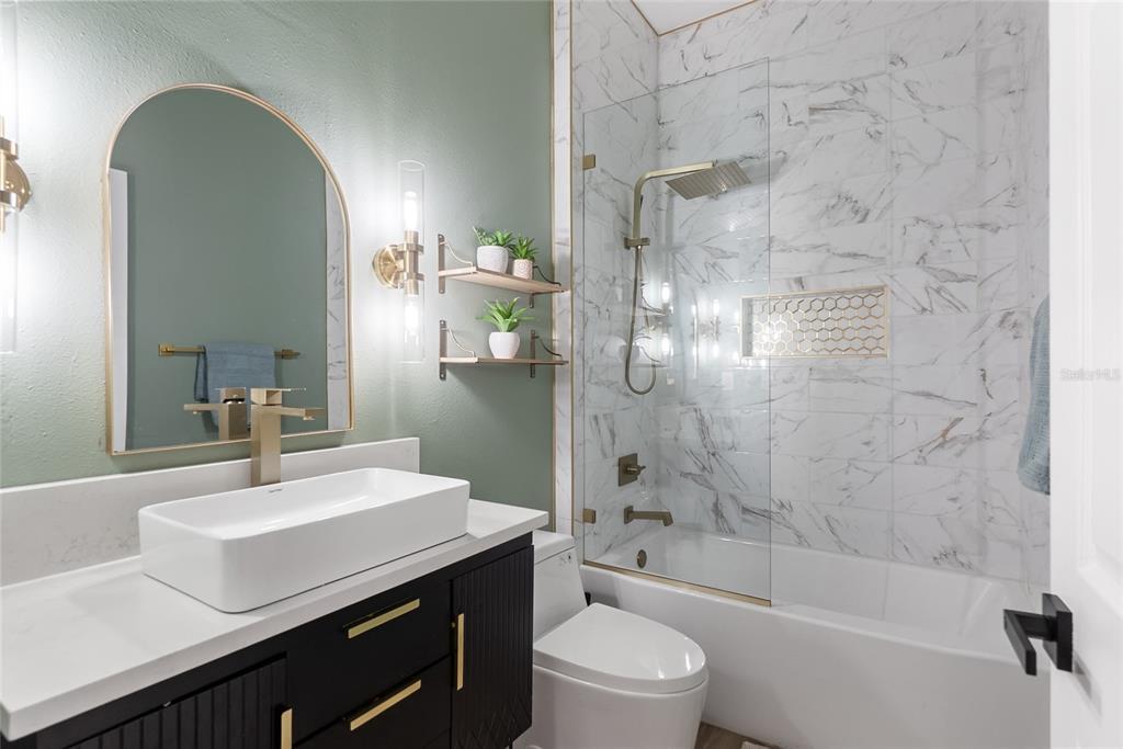 12516 24th Street East Parrish, FL 34219 - Photo 11 of 47 a bathroom with a sink a toilet a mirror and shower