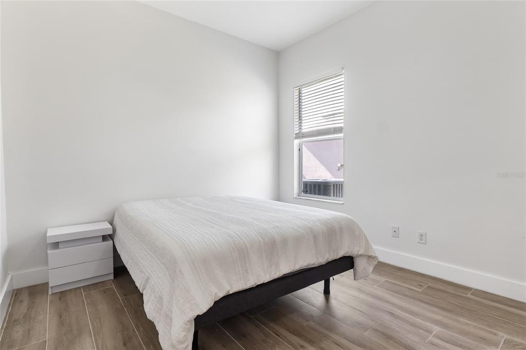 12516 24th Street East Parrish, FL 34219 - Photo 12 of 47 a bedroom with a bed and a window