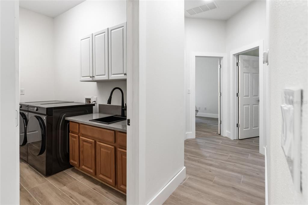 12516 24th Street East Parrish, FL 34219 - Photo 14 of 47 a kitchen with stainless steel appliances granite countertop a stove and a refrigerator