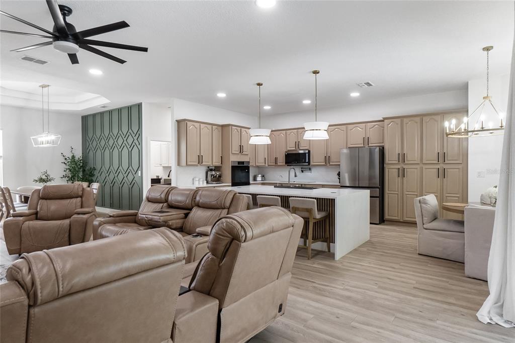12516 24th Street East Parrish, FL 34219 - Photo 18 of 47 a living room with kitchen island furniture and a view of kitchen