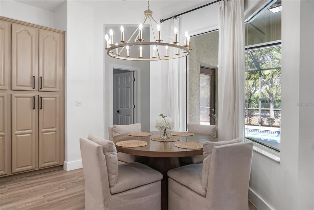12516 24th Street East Parrish, FL 34219 - Photo 20 of 47 a view of a dining room with furniture window and wooden floor