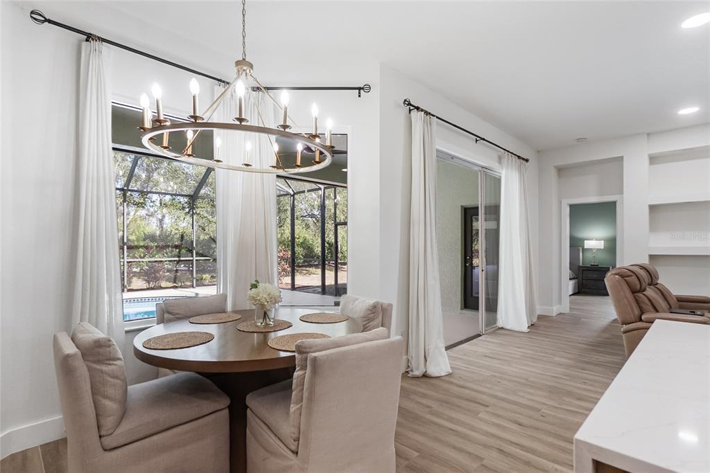 12516 24th Street East Parrish, FL 34219 - Photo 21 of 47 a kitchen with stainless steel appliances granite countertop a sink and a refrigerator
