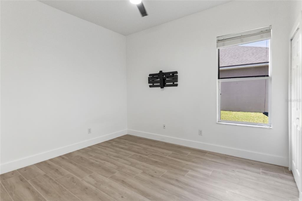 12516 24th Street East Parrish, FL 34219 - Photo 22 of 47 an empty room with a window and a ceiling fan