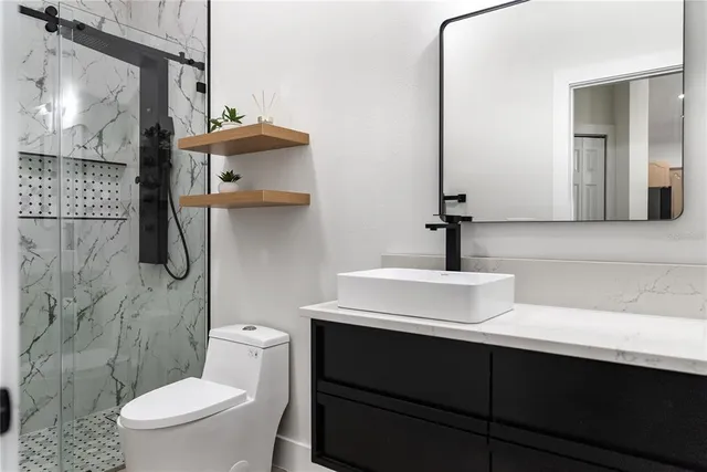 a bathroom with a sink a toilet and mirror