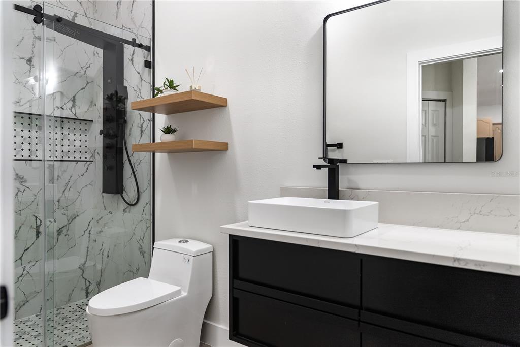 12516 24th Street East Parrish, FL 34219 - Photo 23 of 47 a bathroom with a sink a toilet and mirror