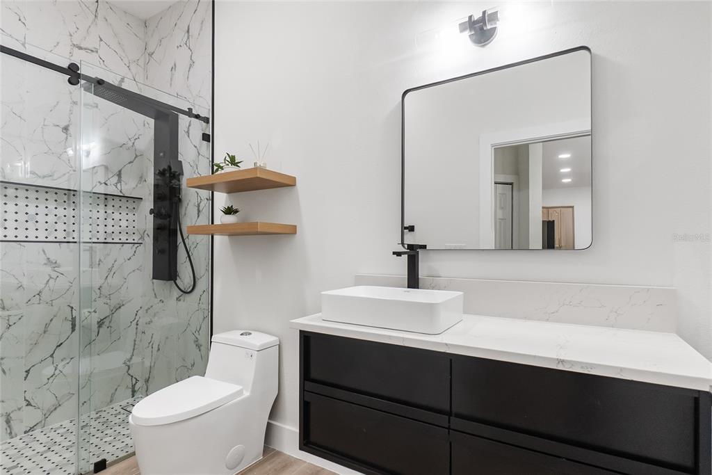 12516 24th Street East Parrish, FL 34219 - Photo 24 of 47 a bathroom with a sink a toilet and shower