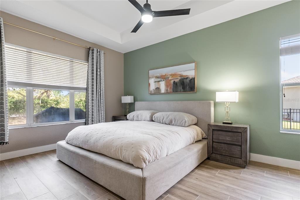 12516 24th Street East Parrish, FL 34219 - Photo 25 of 47 a bedroom with a bed and a painting on the wall