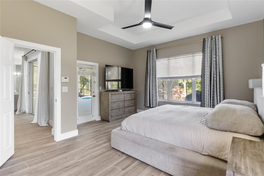 12516 24th Street East Parrish, FL 34219 - Photo 26 of 47 a spacious bedroom with a large bed and a window