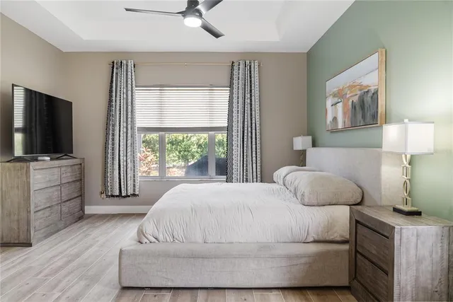 a bedroom with a bed and flat screen tv