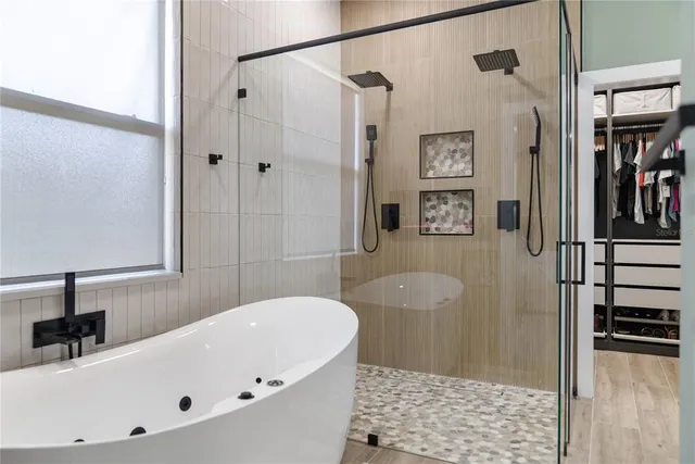a bathroom with a bathtub and a shower
