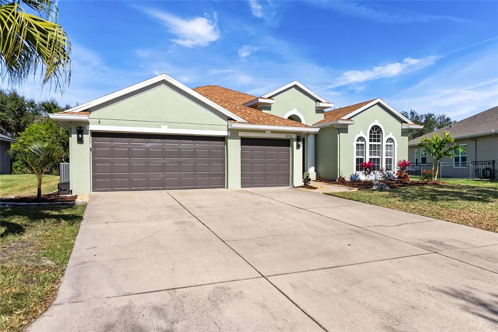 12516 24th Street East Parrish, FL 34219 - Photo 36 of 47 a front view of a house with a yard and potted plants