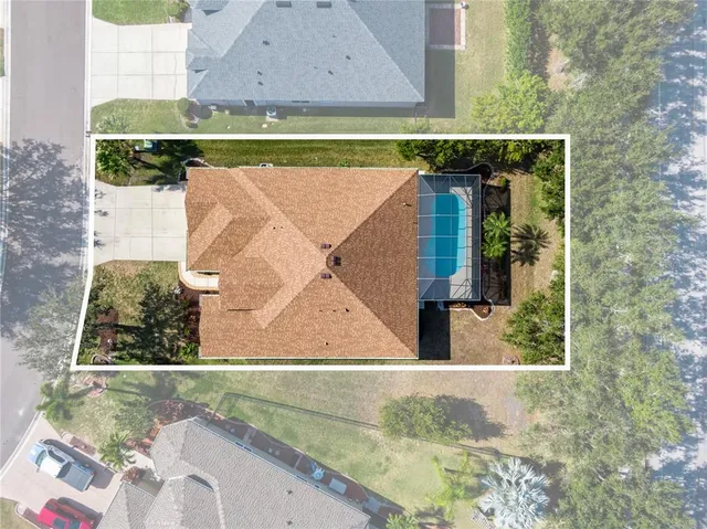an aerial view of residential house with outdoor space and swimming pool