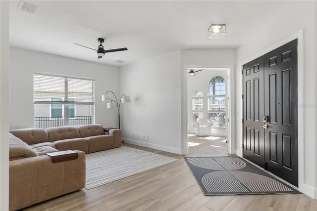 a living room with furniture and a large window
