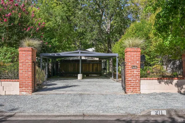 a view of a house with a backyard and floor to ceiling window
