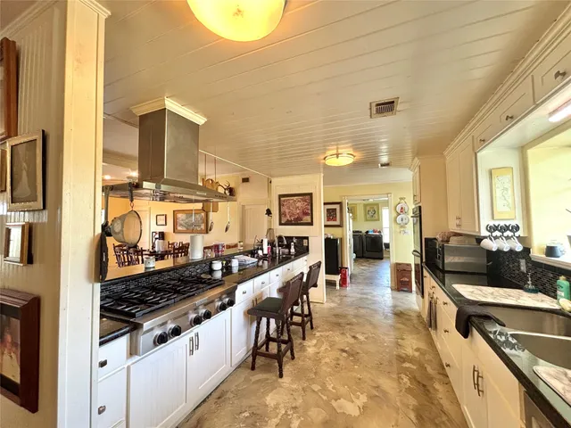 a kitchen with lots of counter top space and stainless steel appliances