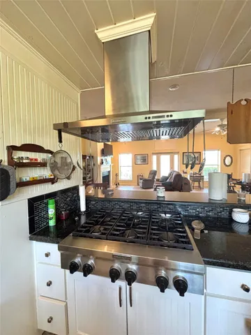 a kitchen with stainless steel appliances granite countertop a sink stove and cabinets