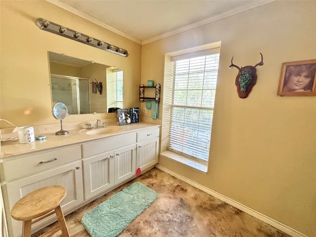 a bathroom with a double vanity sink window and shower