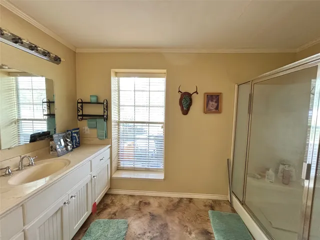 a spacious bedroom with a bed and a chandelier