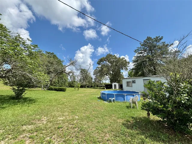 a backyard of a house with lots of green space