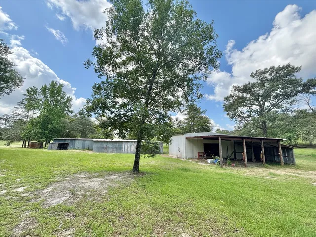 a backyard of a house with table and chairs
