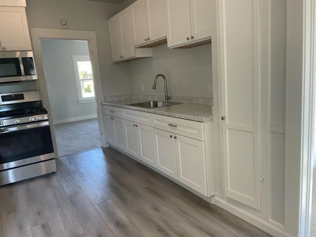 a kitchen with stainless steel appliances a refrigerator and a stove top oven