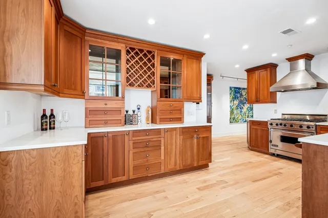a kitchen with stainless steel appliances granite countertop a stove and a sink
